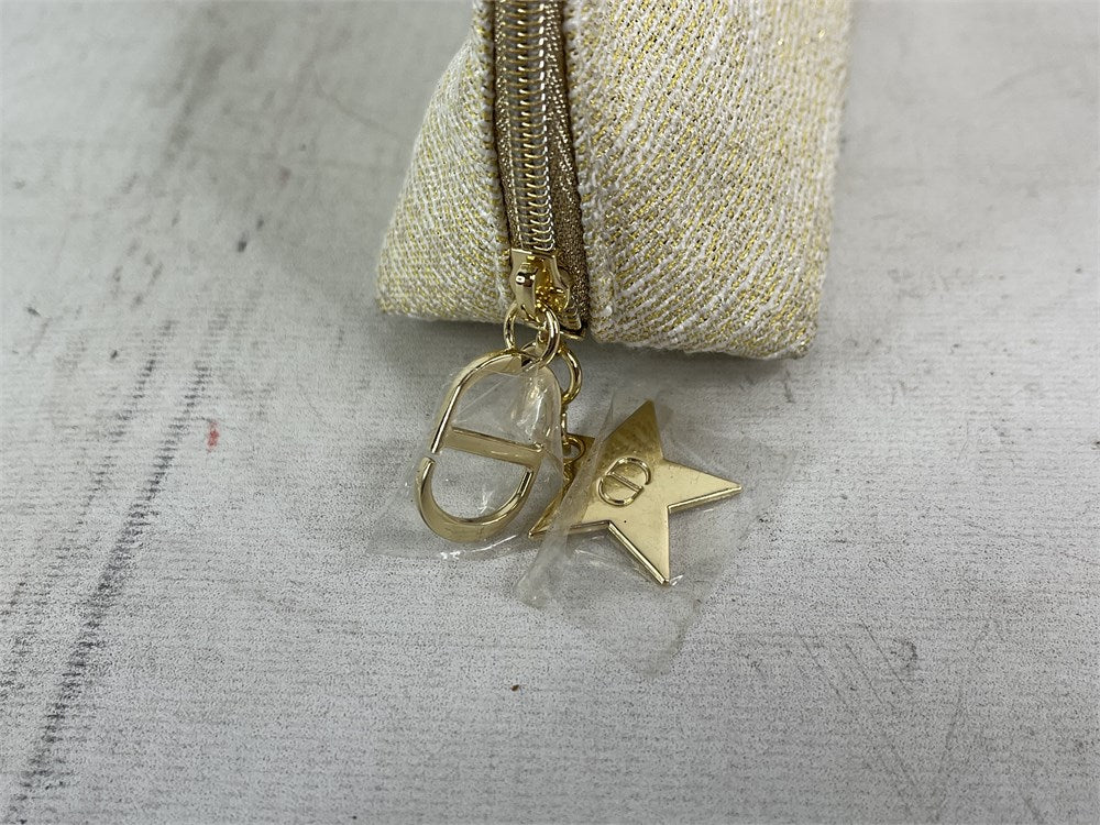 Christian Dior limited edition gold holiday cosmetic pouch zipper charm detail