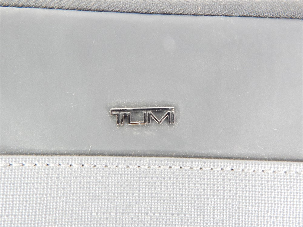 TUMI logo detail from black gray two-pouch source subgroup